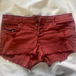 Billabong size 27 color denim distressed button up shorts.